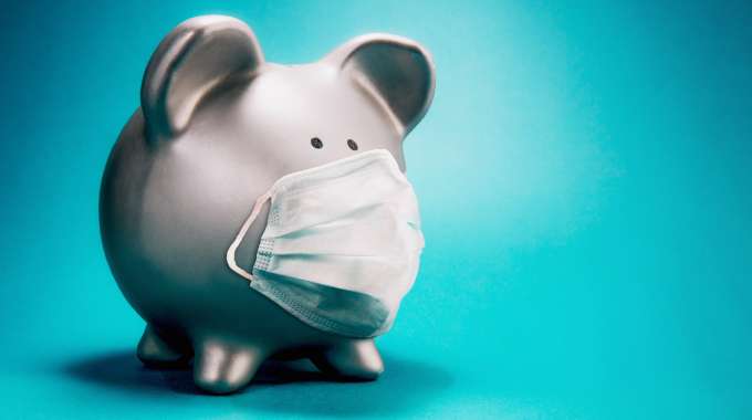 Piggy bank with a COVID-19 face mask