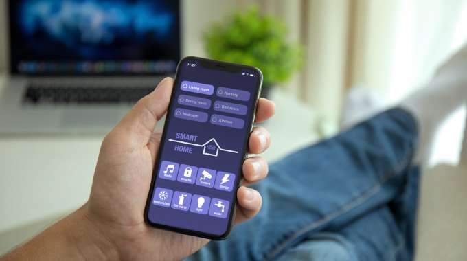 Person controlling their smart home tech on their smartphone