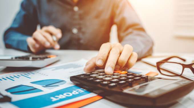 Man with calculator crunching the numbers