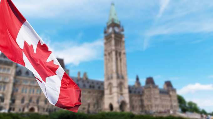 Canadian flag and legislative government building