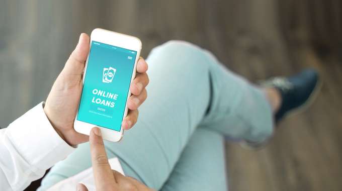 Person applying for an online short-term loan on their smartphone